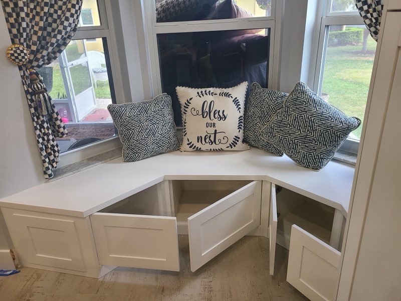 Custom bay-window breakfast banquette with hidden storage under the seat